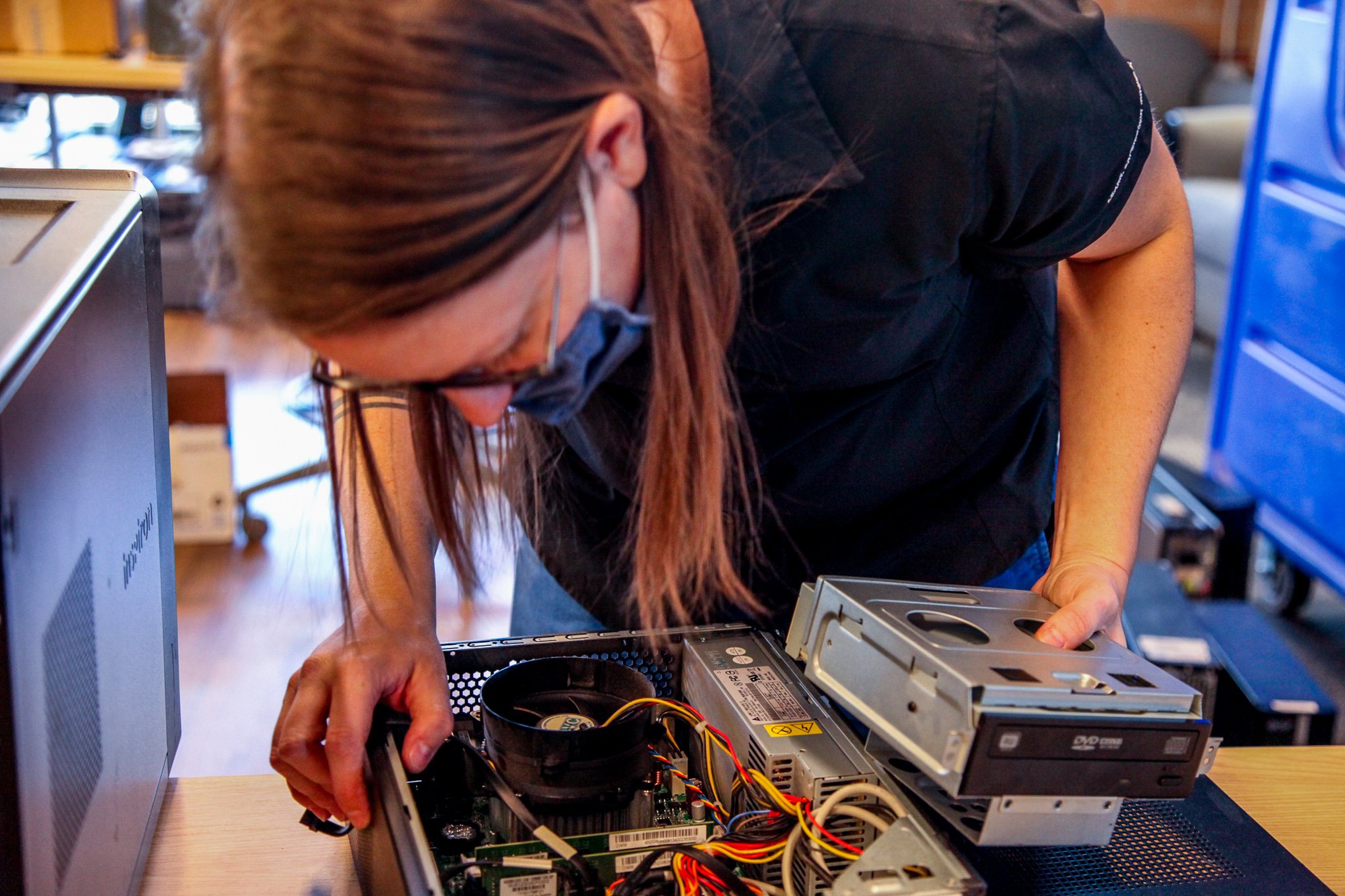 Jacy Smith jumps in to help refurbish the computers.