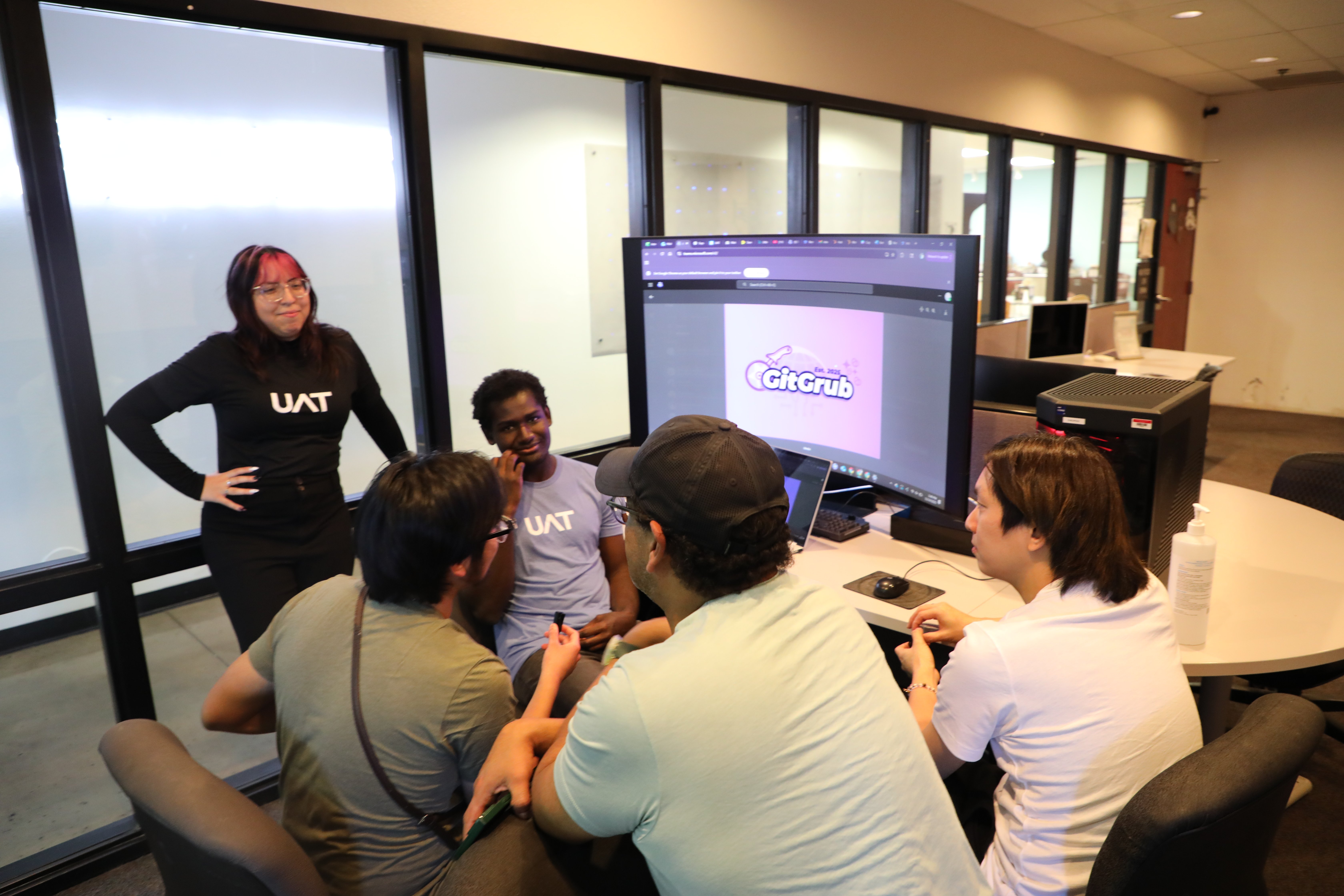 UAT Advertising Art degree students reviewing branding and designs for a student's start-up innovative app.